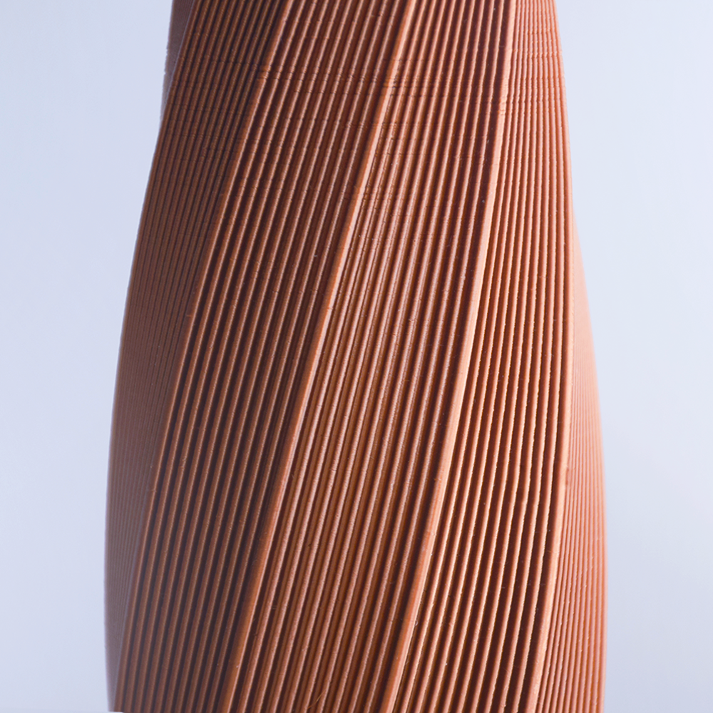 Close-up of a 3d print brown fabric against a light blue background