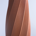 Close-up of a 3d print brown fabric against a light blue background
