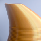 Close-up of a textured yellow vase against a light blue background