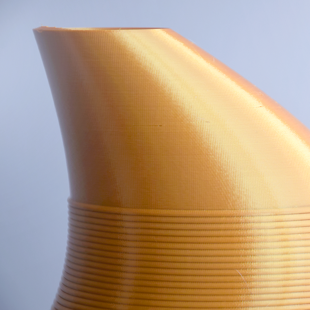 Close-up of a textured yellow vase against a light blue background