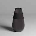 Black vase with textured design on a gray background