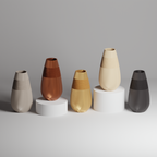 Set of five 3d print vases in various colors on a gray background