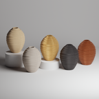 Set of five textured vases in beige, gold, gray, and brown on a light gray background.