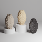 Three geometrically patterned vases on white stands against a gray background