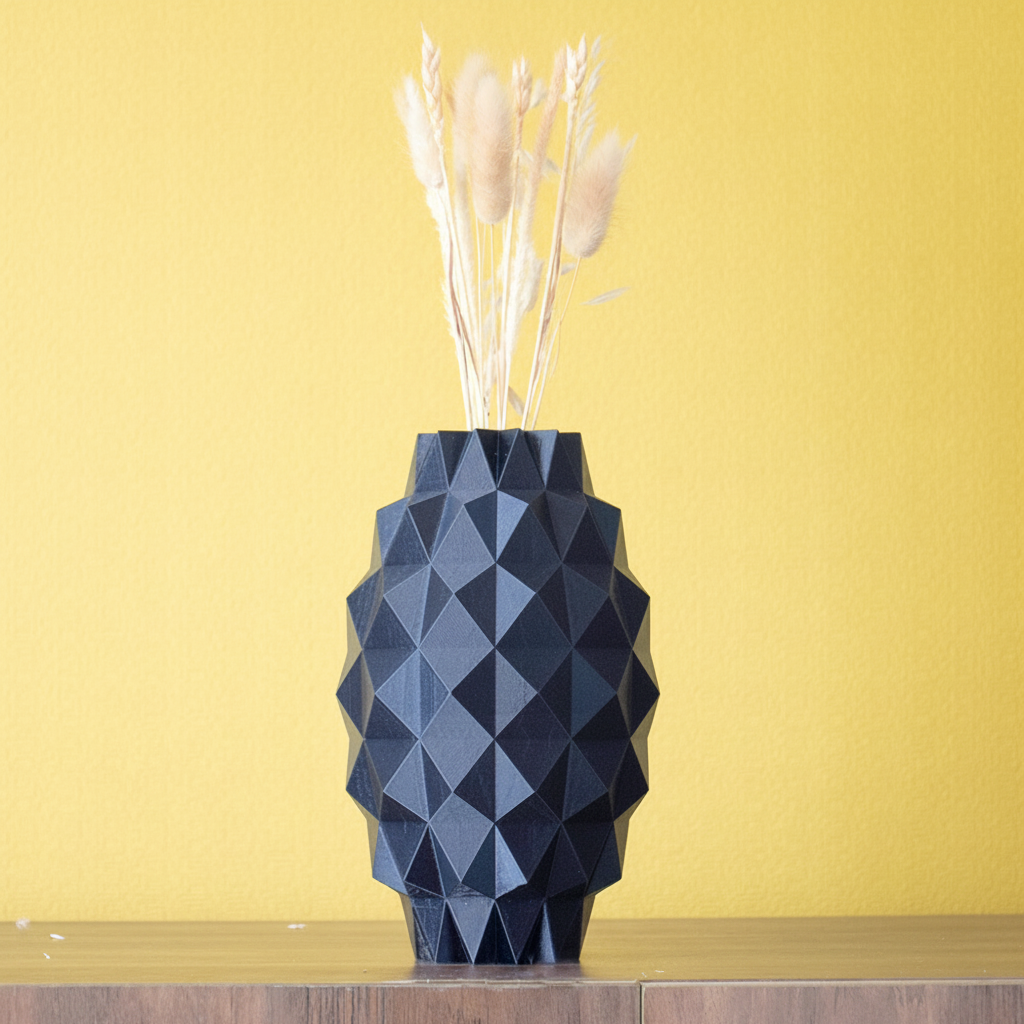 Geometric blue vase with dried plants on a white surface