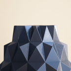 Geometric patterned material with blue and black colors on a light blue background