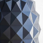 Geometric pattern with blue and gray triangles on a textured surface