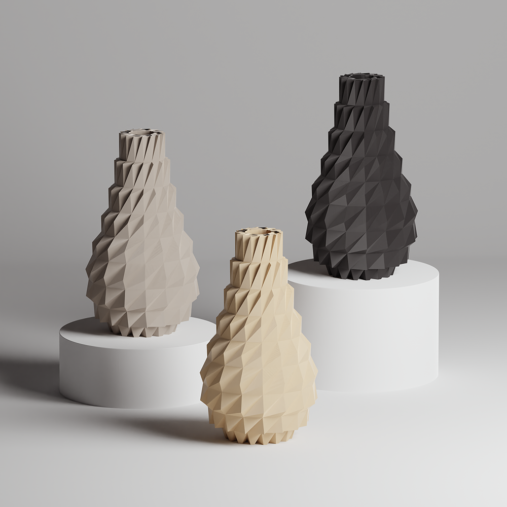 Three geometrically designed vases in gray, beige, and black on a gray background