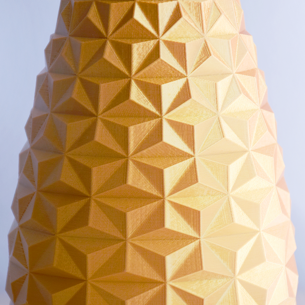 Geometric patterned vase against a clear blue sky