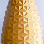 Geometric patterned vase against a clear blue sky