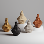 Five textured vases in gold, beige, black, and brown on a gray background