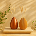 Two decorative vases with dried plants on a wooden platform against a beige wall.